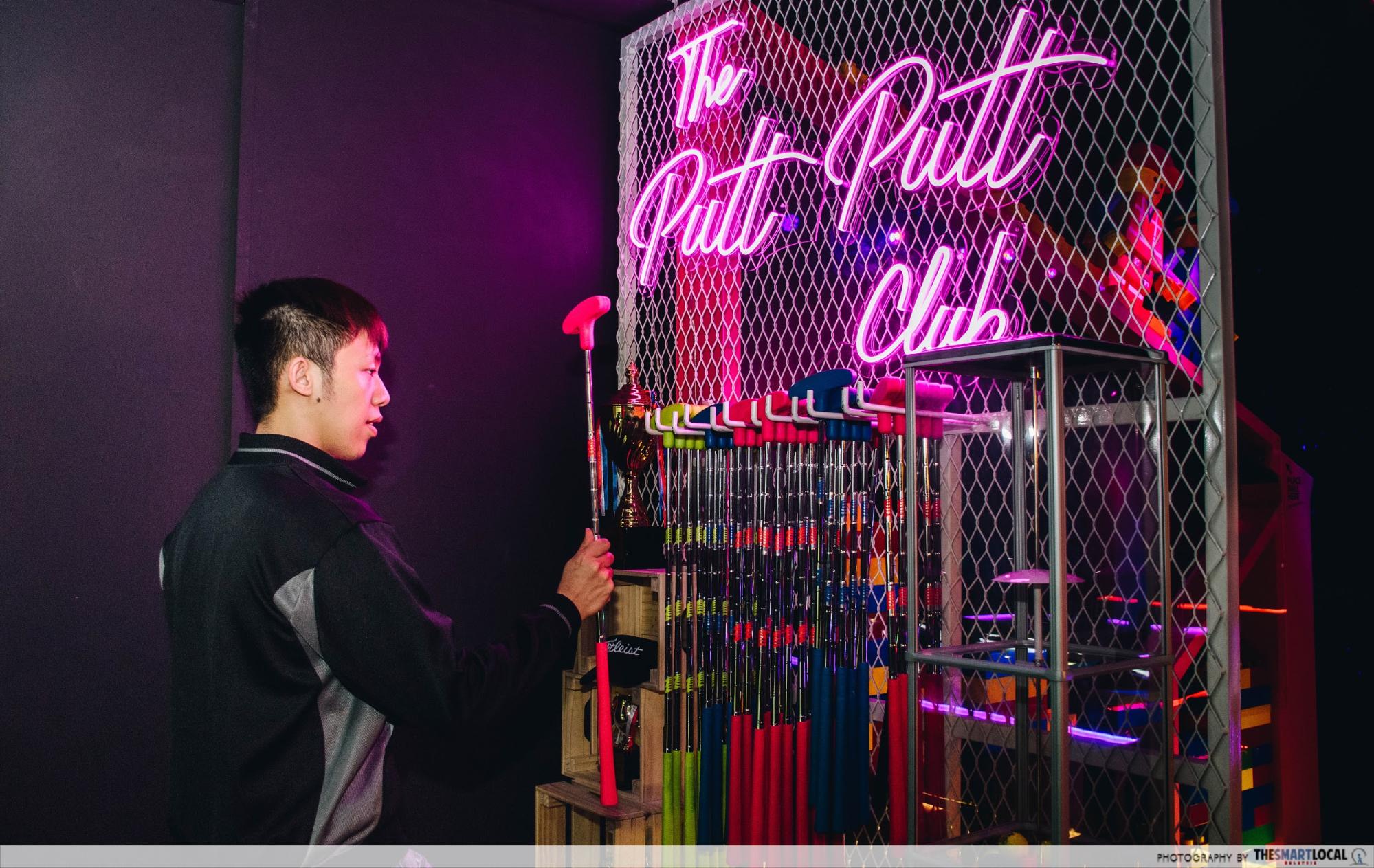 neon sign and putters