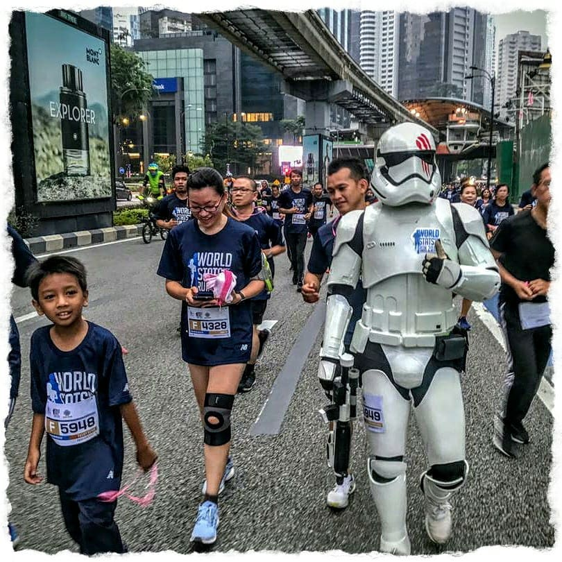 stormtrooper walks with marathon runners