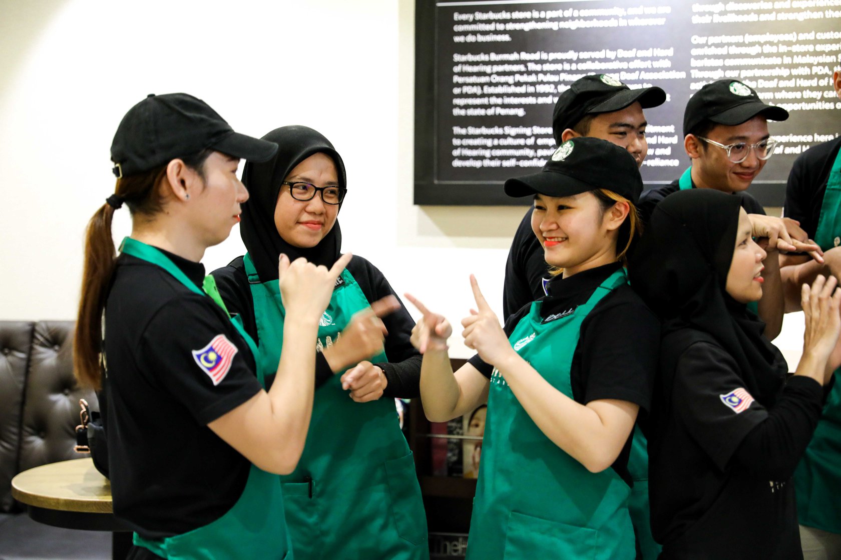 Starbucks staff signing each other