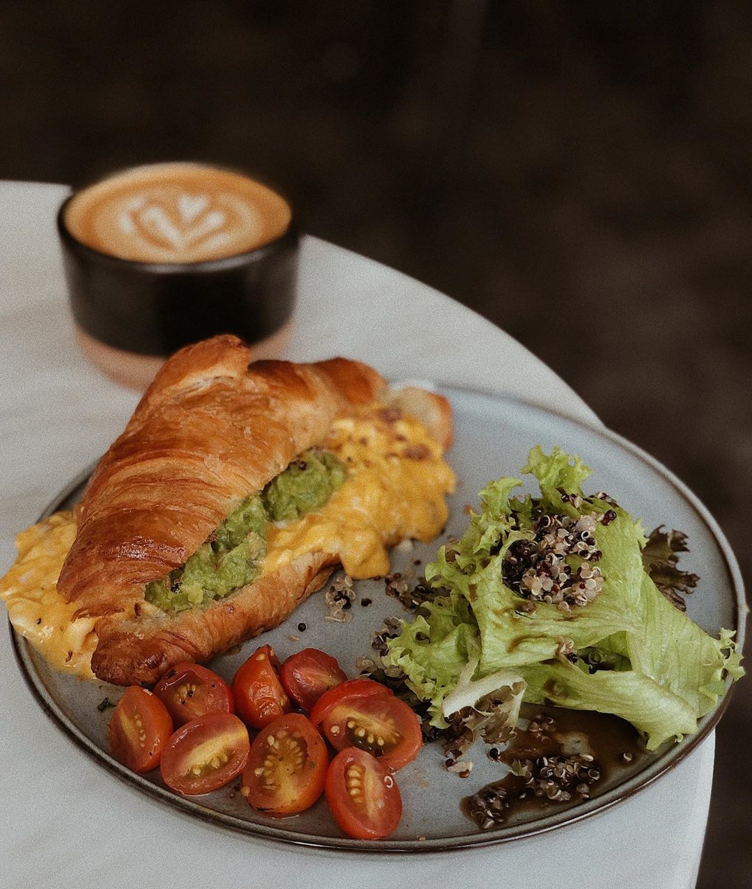 Avocado scrambled eggs croissant