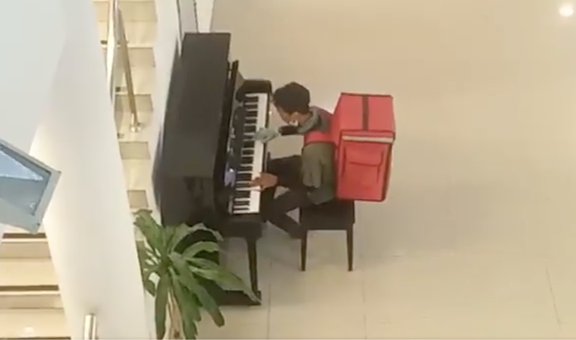 Rider seen playing piano in empty hall