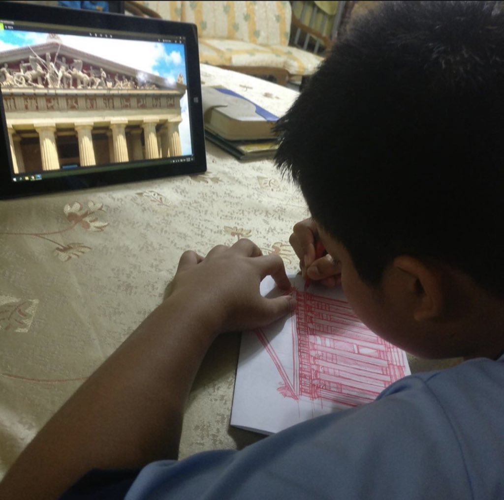 Boy sketches buildings with just a pen