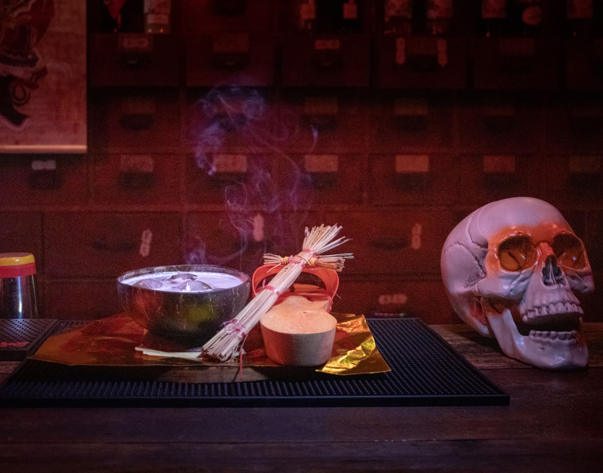 cocktail with skull and voodoo doll as props
