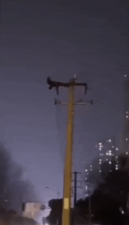 Man causes power outage by doing sit-ups on telephone pole - video
