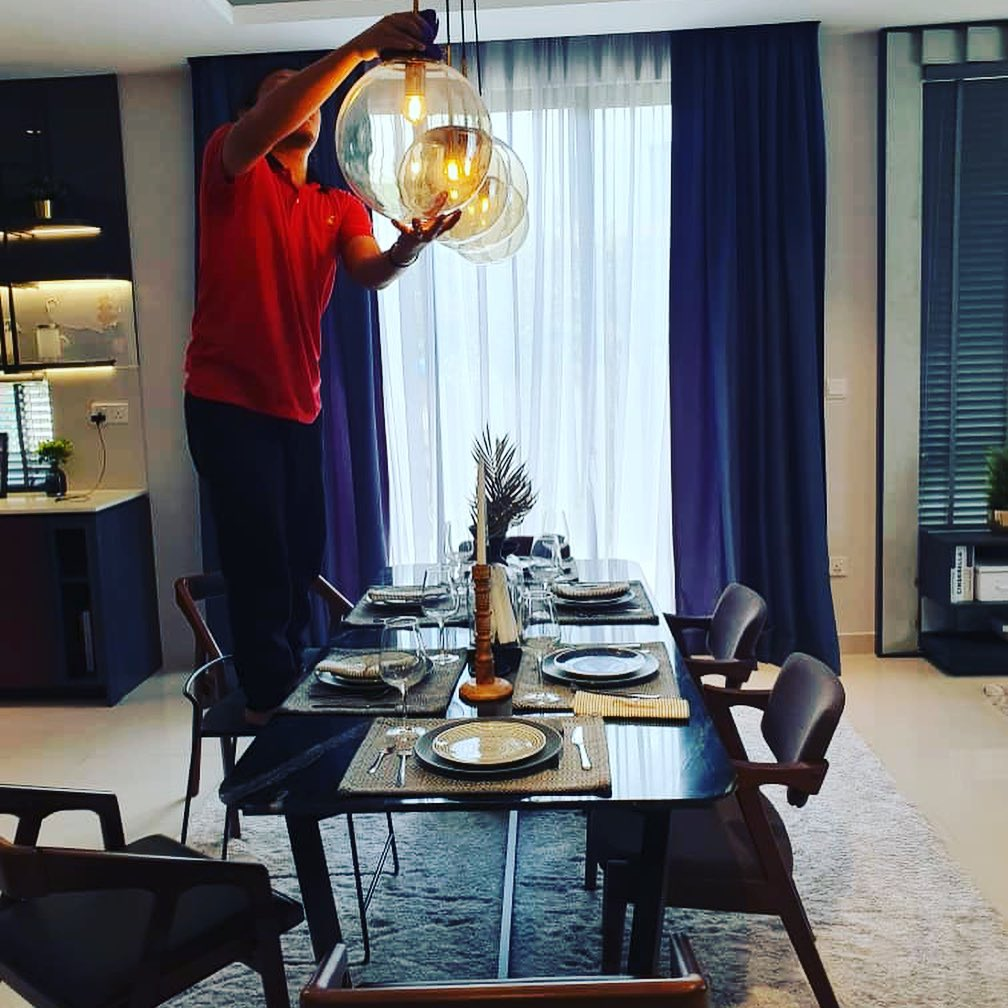 Ultra Cleaning - man cleaning ceiling lights