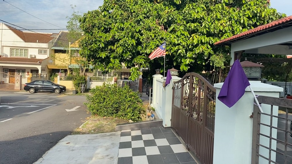 Purple flag in front of a house