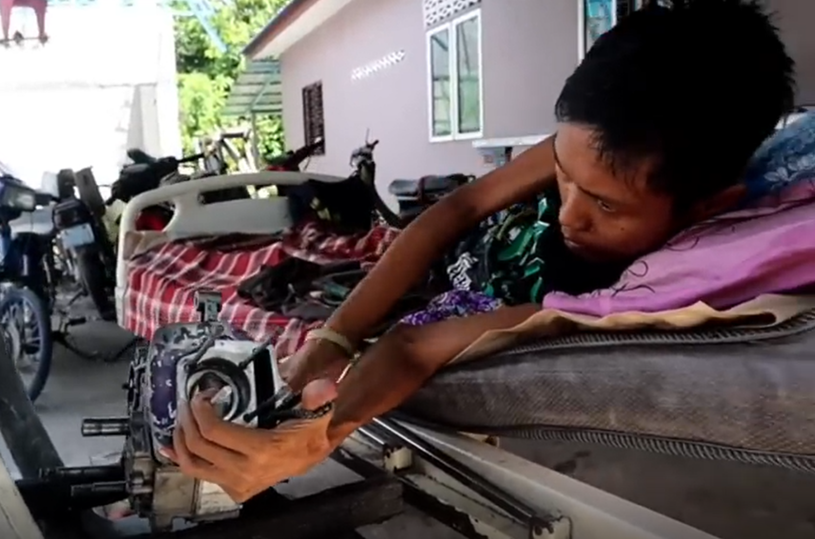 bedridden repairs motorcycle - fix from bed