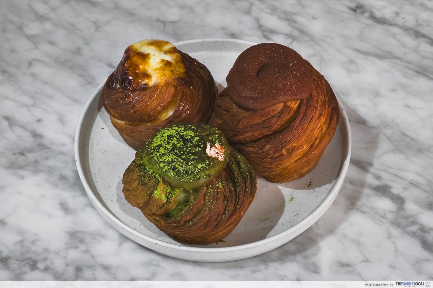 original yoghurt cheese, matcha, and chocolate cup-like croissants on a plate
