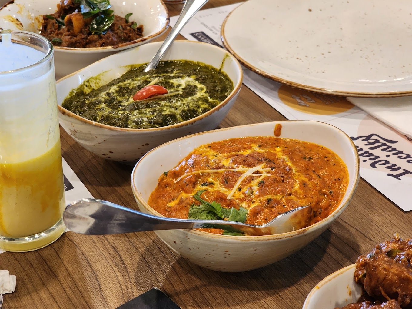 bowls of butter chicken and palak paneer