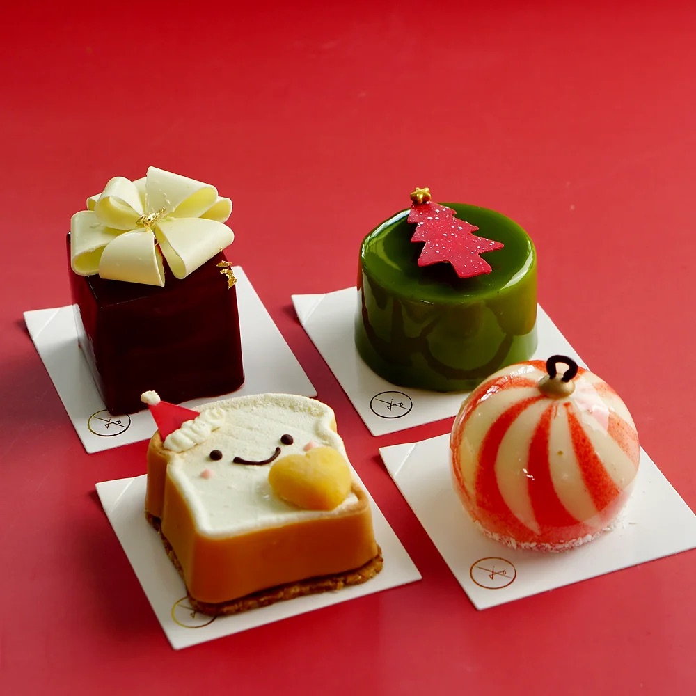 four french-style mini mousse cakes with Christmas designs