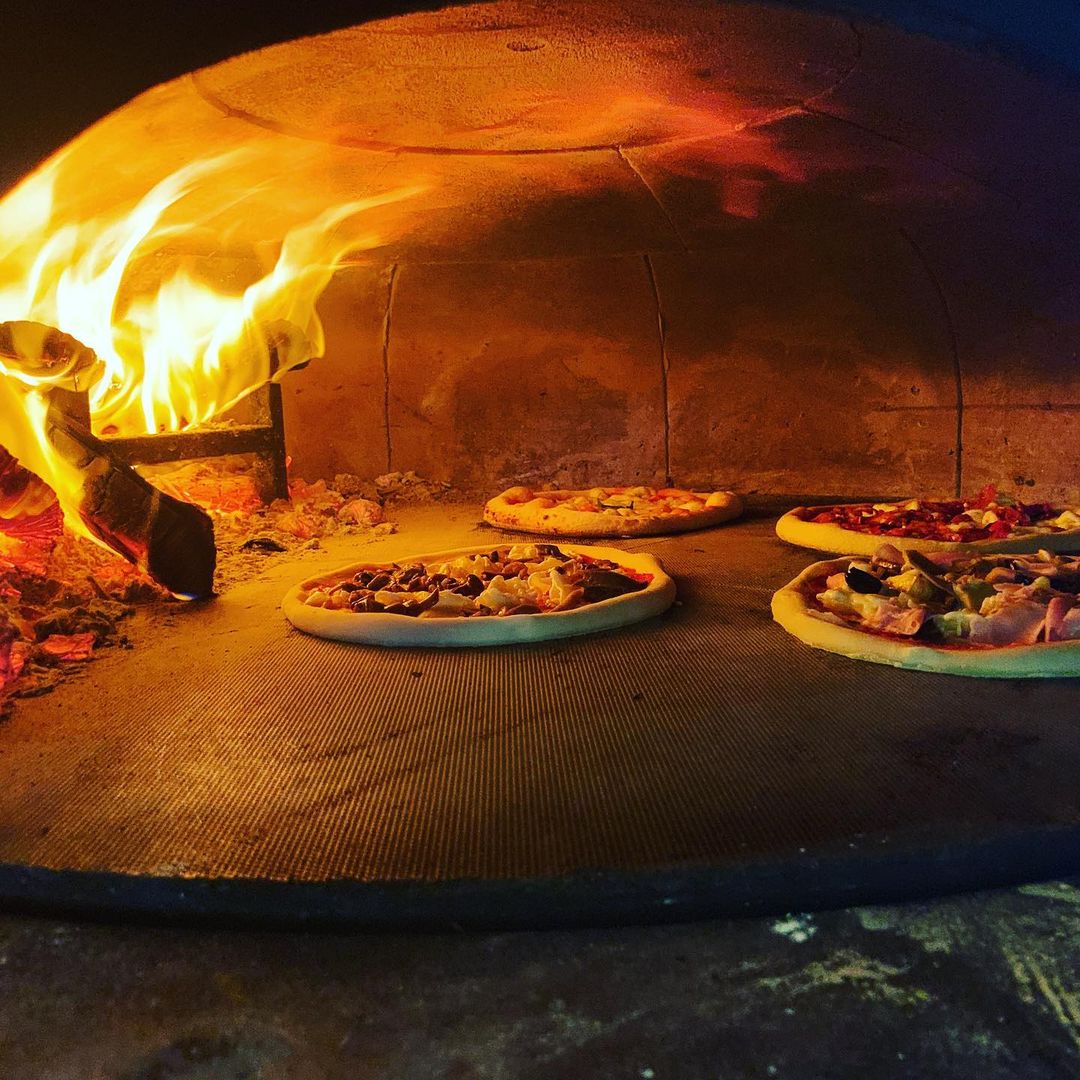 Italian wood-fired pizzas getting baked