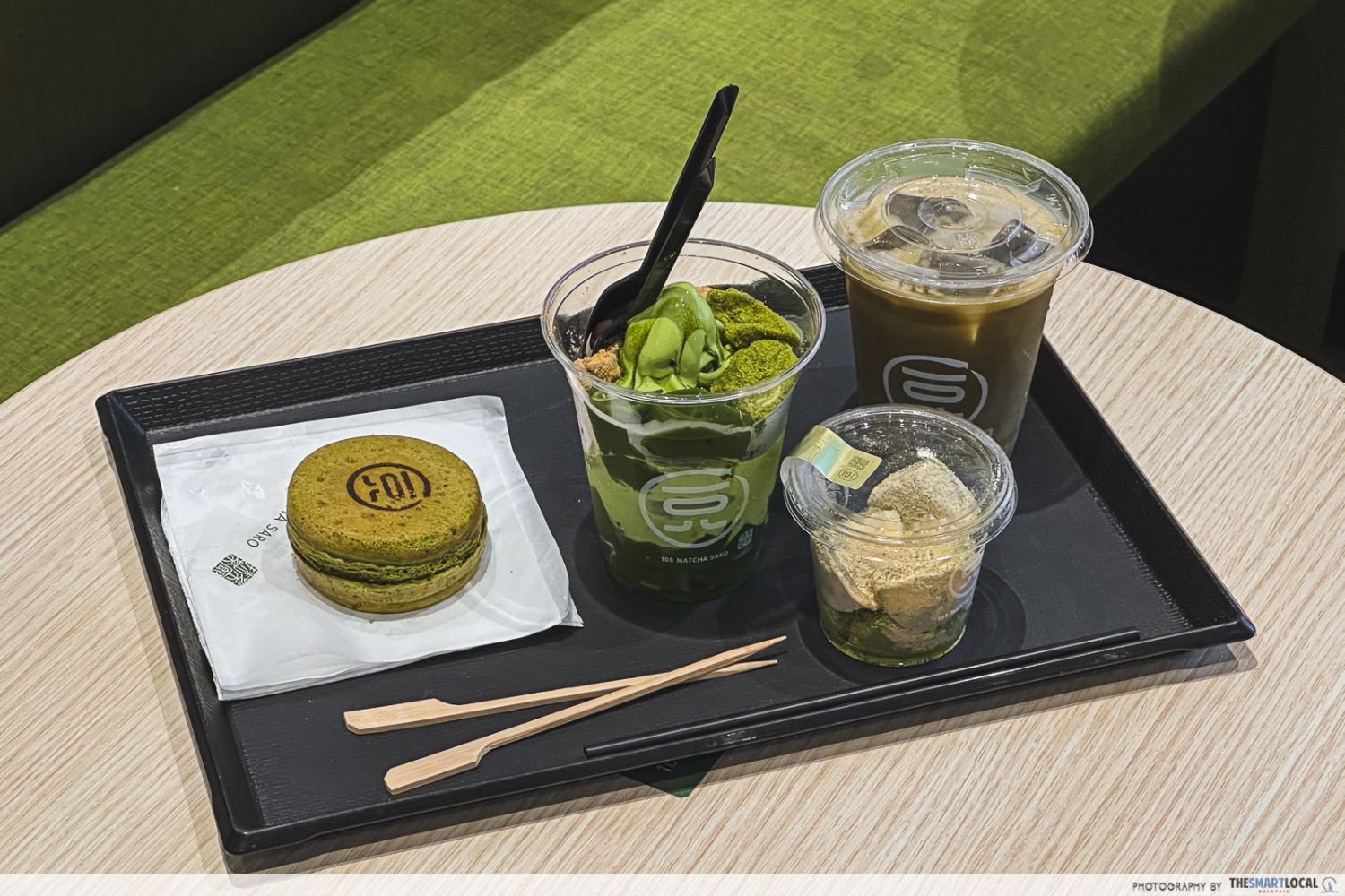obanyaki. matcha parfait, warabi mochi, and iced hojicha latte gathered on a tray
