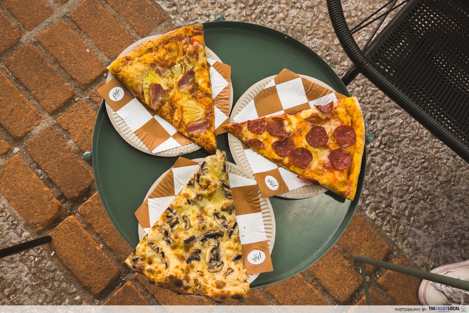 three indvidual slices of pizza on separate plates, there are pepperoni, pineapple sugus, and truffle pizzas