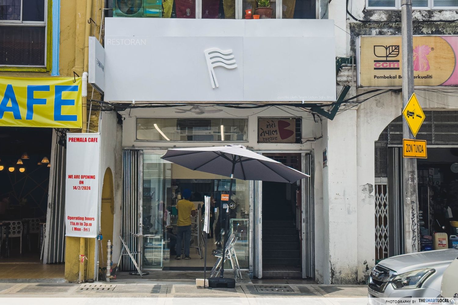 the shopfront of team udon with silver-coloured signage