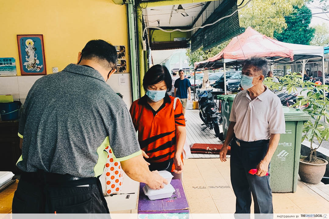 Uncle giving food - V Fortune Land Vegetarian Cafe in KL