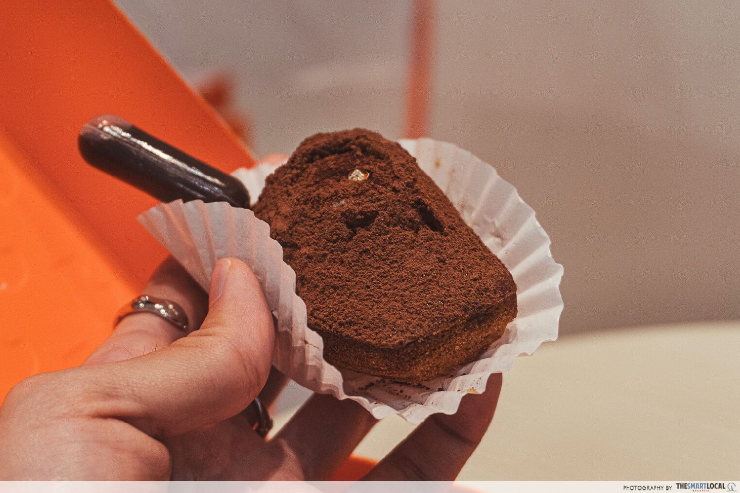 tiramisu madeleine injected with a small capsule of espresso extract, dusted with cocoa powder