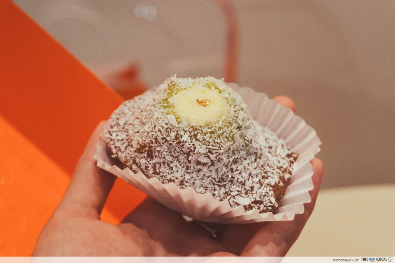 a Malaysian-accented pandan coconut madeleine flecked with coconut shreds