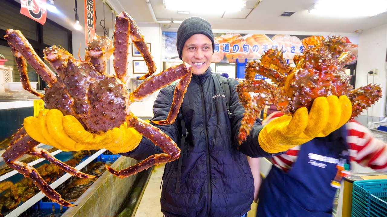 Mark Weins holding giant crabs in Japanese Market